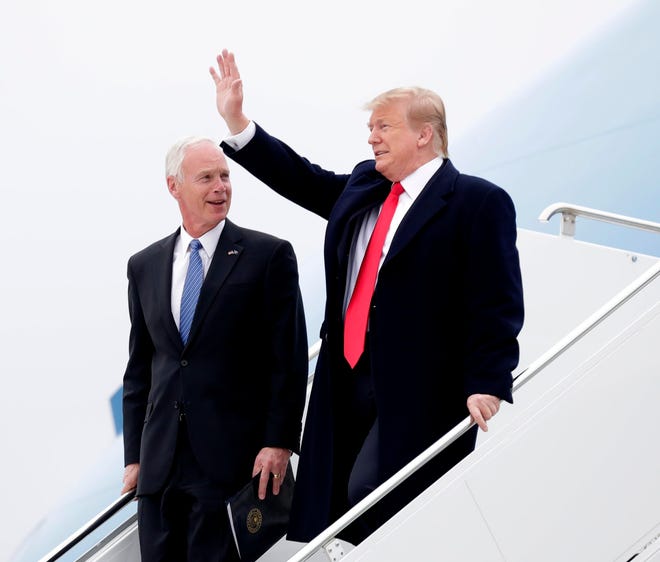 President Donald Trump arrives  with Wisconsin Senator Ron Johnson to deliver a speech to supporters in Green Bay.