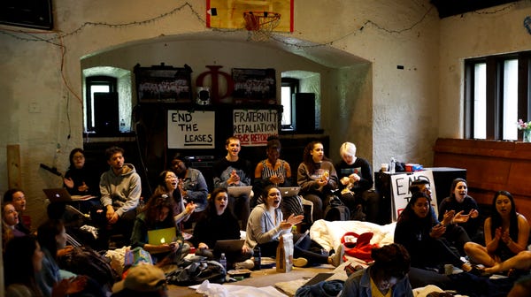 Swarthmore College students sing during a sit-in...