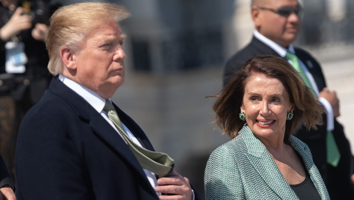 (FILES) In this file photo taken on March 14, 2019 US President Donald Trump walks alongside Speaker of the House Nancy Pelosi as he departs following the Friends of Ireland Luncheon in honor of Irish Prime Minister Leo Varadkar at the US Capitol in Washington, DC. - Top US Democrats on March 22, 2019, demanded the full special counsel report on Russian interference in the 2016 election be released publicly with no "sneak preview" for President Donald Trump.   Many of the party's challengers for the 2020 presidential nomination, including senators Bernie Sanders and Kamala Harris, swiftly joined calls for full transparency after Special Counsel Robert Mueller submitted his report to Attorney General Bill Barr. "It is imperative for (Attorney General Bill) Barr to make the full report public and provide its underlying documentation and findings to Congress," House Speaker Nancy Pelosi and Senate Minority Leader Chuck Schumer said in a joint statement. (Photo by SAUL LOEB / AFP)SAUL LOEB/AFP/Getty Images ORIG FILE ID: AFP_1EY9BK