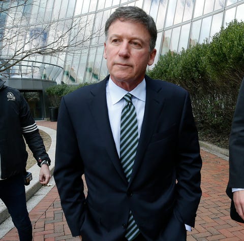 Bruce Isackson departs federal court in Boston on...