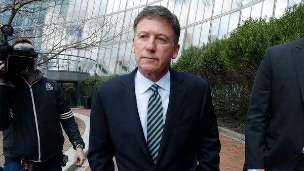 Bruce Isackson departs federal court in Boston on...