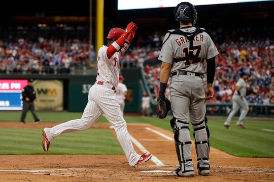Philadelphia Phillies' Andrew McCutchen runs past Detroit Tigers catcher Grayson Greiner, scoring off of a hit by Rhys Hoskins in the first inning Wednesday. The Phillies won 6-3 to split the two-game interleague series.