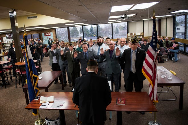 Members of the new Berthoud VFW Post 12189 Spc. Gabriel Conde Memorial take an oath of installation from Colorado Veterans of Foreign Wars state commander Steve Kjonaas, center, at the chartering ceremony for the post on Tuesday, April 30, 2019, at Berthoud High School in Berthoud, Colo. Exactly one year after 22-year-old Spc. Gabriel Conde was killed in the line of duty in Afghanistan, a Berthoud Veterans of Foreign Wars was chartered to carry on his name and legacy.