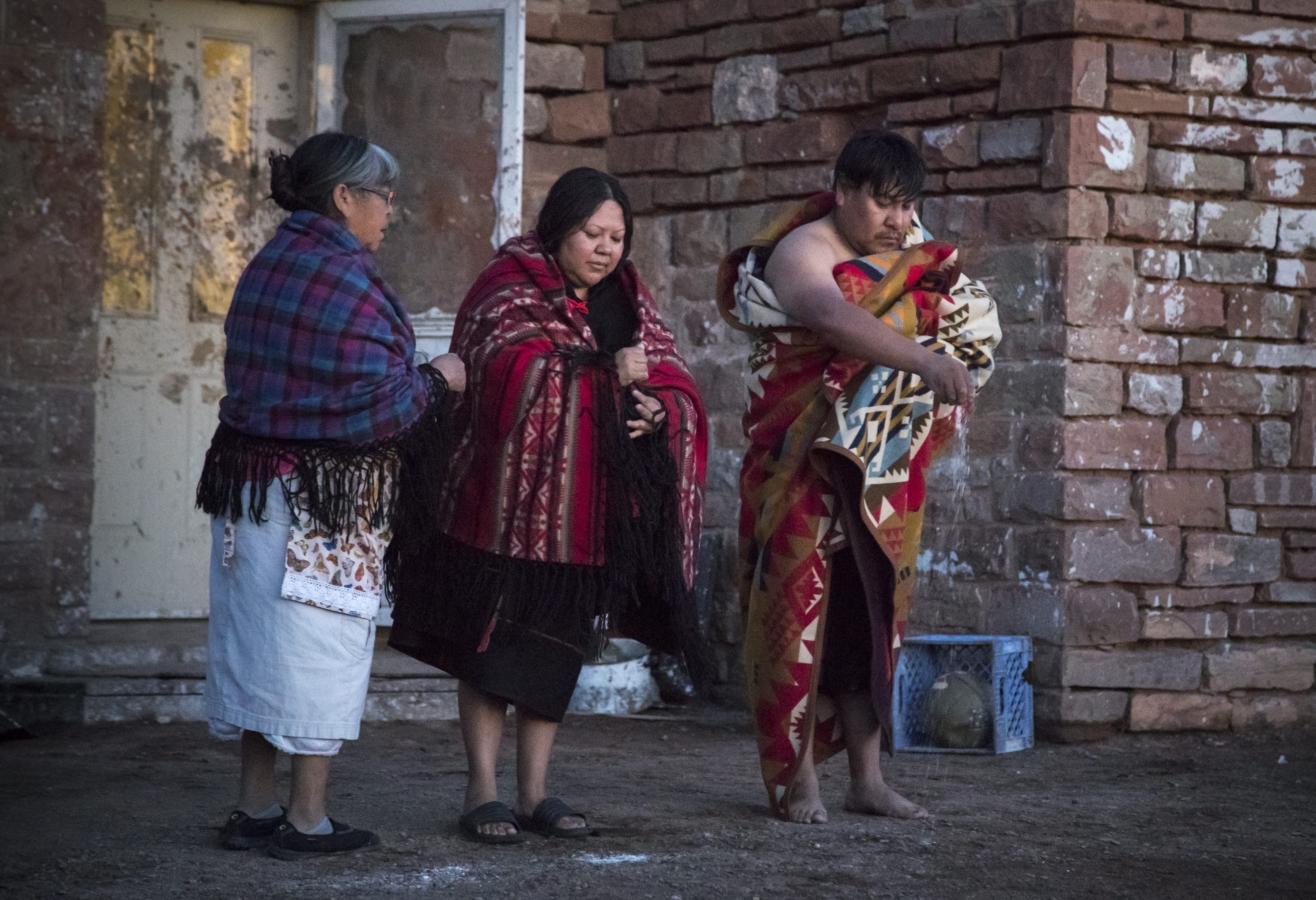 After the bath, the couple was walked outside to the front of the house where they sprinkled white cornmeal toward the rising sun to bless the marriage, bringing the wedding ceremony to an end.