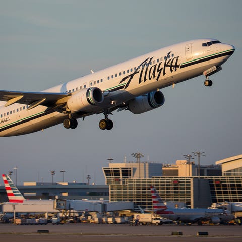 An Alaska Airlines Boeing 737-900 takes off from...