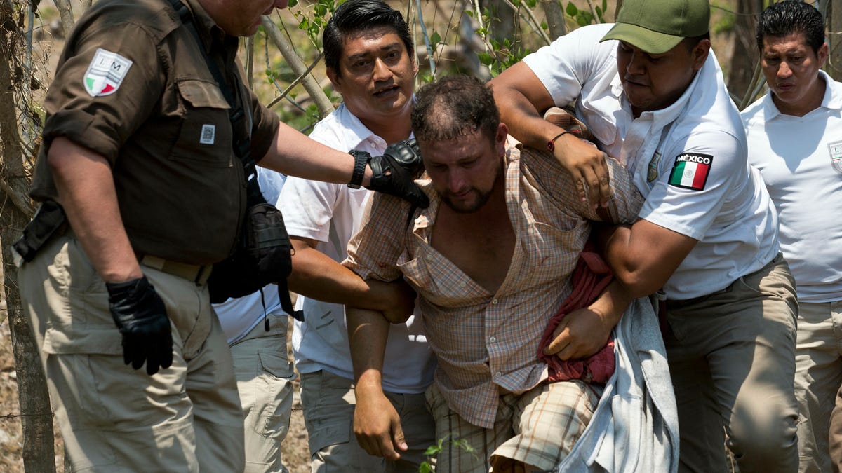 A Central American migrant is detained by Mexican immigration agents on the highway to Pijijiapan, Mexico, on April 22, 2019. Mexican police and immigration agents detained hundreds of Central American migrants Monday in the largest single raid on a migrant caravan since the groups started moving through Mexico last year.