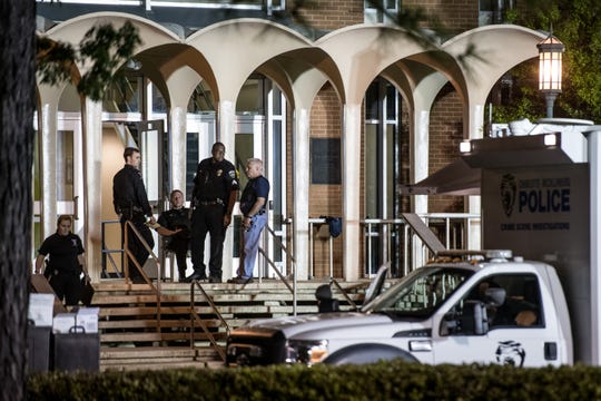 Charlotte-Mecklenburg law enforcement stand in front of the Kennedy building where a gunman killed two people and injured four students at UNC Charlotte. Campus police responded to the scene on Tuesday and apprehended a suspect, 22-year-old Trystan Andrew Terrell.