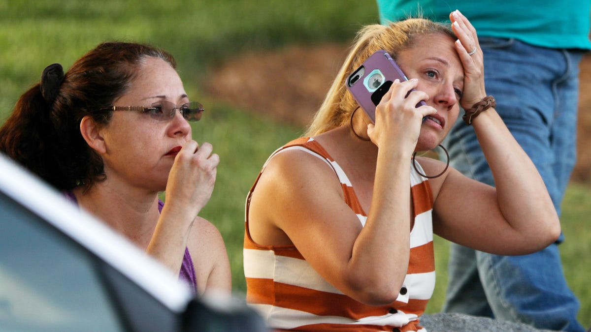 Family members and friends wait for their loved ones at a staging area after a shooting on the campus of University of North Carolina Charlotte in University City, Charlotte, on April 30, 2019.  At least two people were killed and several wounded in a shooting at the University of North Carolina's Charlotte campus.