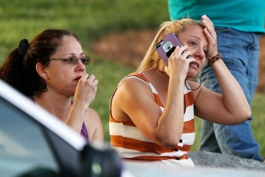 Family members and friends wait for their loved ones after a shooting on the campus of University of North Carolina-Charlotte.