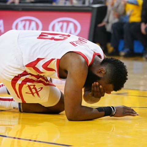 Rockets guard James Harden (13) reacts after...
