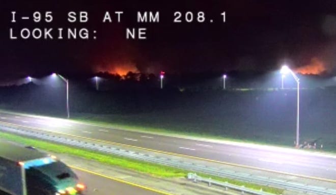 This Interstate 95 traffic camera shows the Tiger Fire burning Wednesday night near the Port St. John Parkway.