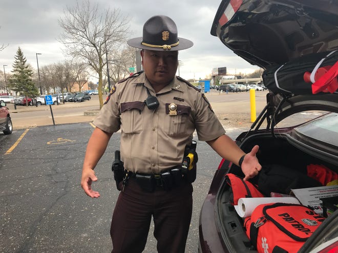 Peter Bachhuber, a Minnesota State trooper, describes the gear troopers carry in their squad cars in St. Cloud on Monday, April 29th.