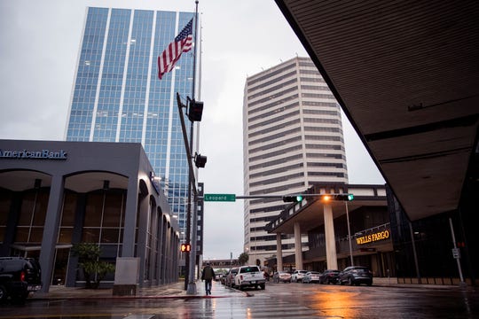 A man walks through the rain in the uptown area on Friday, May 3, 2019. A system of severe thunderstorms were forecast to move over South Texas bringing high winds and potential hail.