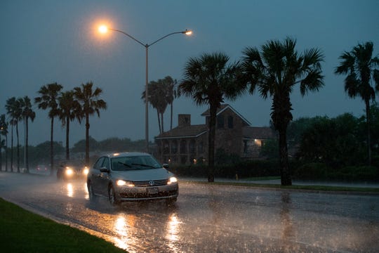 Drivers try to navigate slick roads in Corpus Christi as storms dump rain and bring high winds to the area on Friday, May 3, 2019.