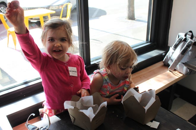 Audrey Sturzinger, 4, and Claire Sturzinger, 2, are happy customers at Bigwig Donuts soft opening on May 3, 2019