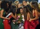 Miss North Carolina Chelsie Kryst, middle, is mobbed by fellow contestants after winning the Miss USA 2019 at the Grand Sierra Resort in Reno on May 2, 2019.