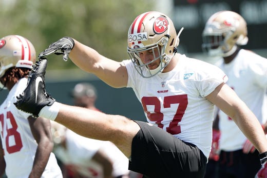 San Francisco 49ers defensive lineman Nick Bosa warms up before practice during rookie minicamp at the SAP Performance Facility.