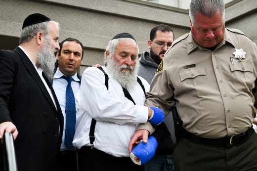 Rabbi Yisroel Goldstein leaves his temple after speaking at a press conference in front of Chabad of Poway synagogue on April 28, 2019. One woman was killed and three others were wounded the day before when a man entered the synagogue during Passover services and opened fire with an AR-style assault weapon shortly before 11:30 a.m. 