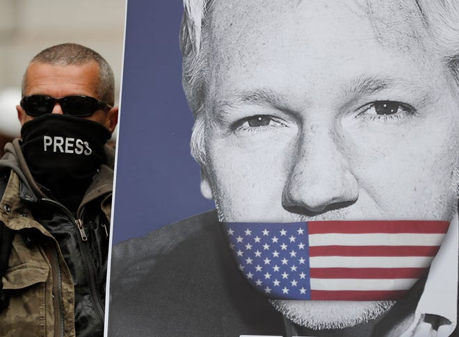A supporter of Julian Assange with a poster of the WikiLeaks founder in London on May 2, 2019.