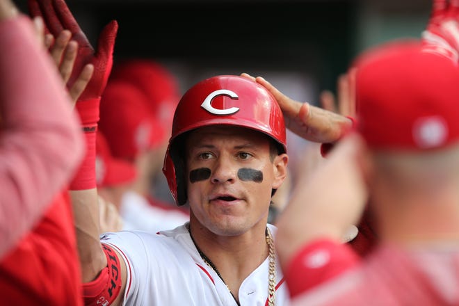 Cincinnati Reds left fielder Derek Dietrich is congratulated in the dugout after hitting a three-run home run in the first inning against the San Francisco Giants at Great American Ball Park on Friday, May 3, 2019.