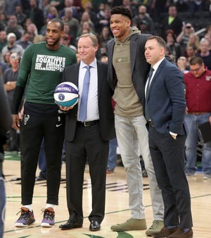 Milwaukee Bucks GM Jon Horst (far right) poses for a photo with (from left) forward Khris Middleton, head coach Mike Budenholzer and Giannis Antetokounmpo as they are recognized at Fiserv Forum in February before taking part in the NBA All-Star Game festivities later that month.