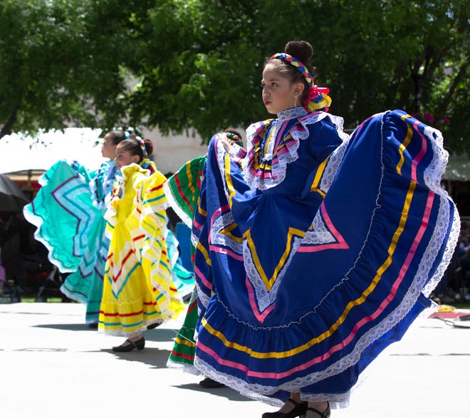 Folkloric ballet dancers show off their dresses Saturday May 4, 2019, at Mesilla Plaza, during a Cinco de Mayo celebration.