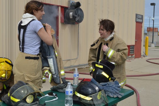 State Sen. Dayna Polehanki, left, and state Rep. Laurie Pohutsky chat after a Fire Ops 101 drill on Saturday, May 4, 2019.