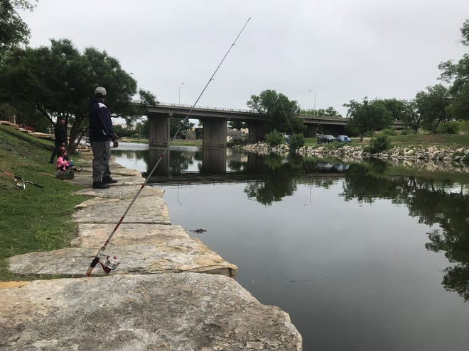 A pole is set up to catch catfish as Will Robinson and his kids enjoy the day at the Concho River Saturday, May 4, 2019.