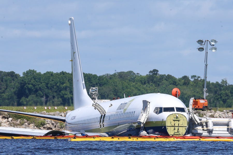 A charter plane carrying 143 people and traveling from Cuba to north Florida sits in a river at the end of a runway, Saturday, May 4, 2019 in Jacksonville, Fla.  