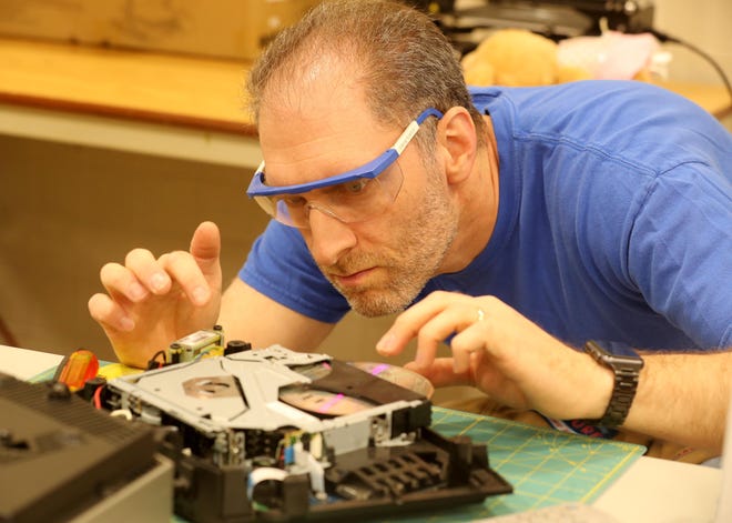 Scott Marchfeld of New City helps repair a CD player belonging to Terry Wengryn of Suffern at the Repair Cafe at the Rockland BOCES' Jesse J. Kaplan School in West Nyack May 5, 2019. Volunteers were on hand to repair items including electronics, cell phones, furniture and jewelry. The event was  sponsored and hosted by Rockland County and its Solid Waste Management Authority and Conservation & Service Corps. Another Repair Cafe will be held in Suffern on October 20th. 
