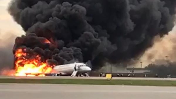 Russian plane lands in flames in Moscow