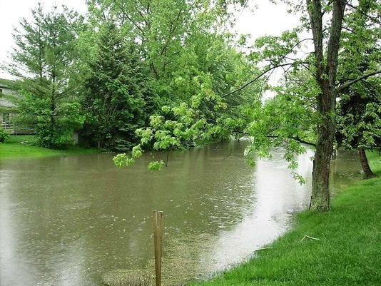 The creek that flows through Mayfair Village subdivision in Canton Township floods regularly after hard rains.