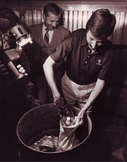 Assistant U.S. Attorney Guy Blackwell with one of several barrels of coins recovered in April 1987 from  bankrupt financier C.H. Butcher Jr., who had concealed many assets following the 1983 failure of his bank.