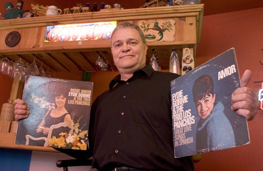 Disc jockey Paco Cruz holds two of his many Eydie Gormé records in his music room at his home in Phoenix in 2006.