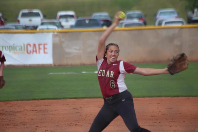 Cedar's Kenzie Waters delivers a pitch with a wind up.
