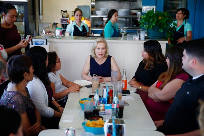 Democratic presidential candidate Sen. Kirsten Gillibrand, center, meets with community activists on immigration issues at a restaurant, Monday, May 6, 2019, in Las Vegas. (AP Photo/John Locher)