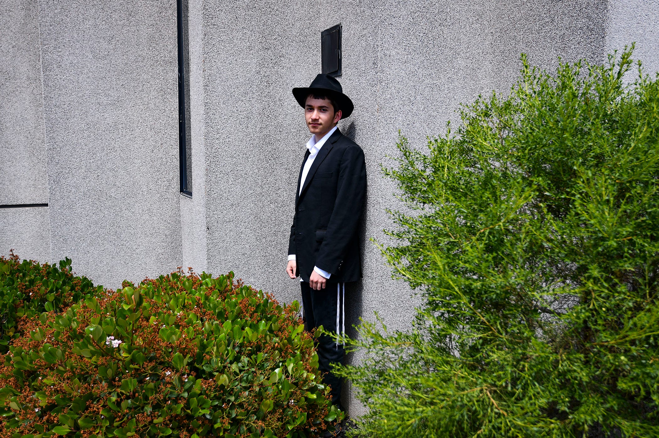 Asher, 17, was sitting inside the sanctuary when the shooting started. After hearing multiple gunshots, he ducked, ran outside and hid behind bushes near the synagogue.