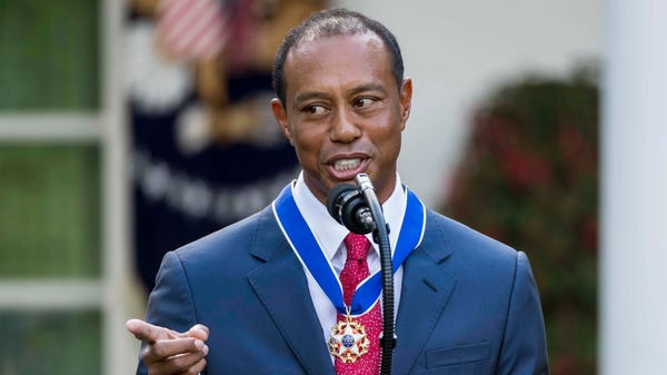 Tiger Woods speaks at a ceremony after being...