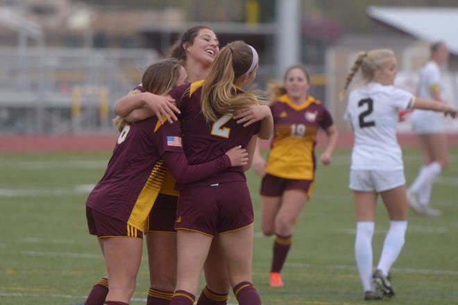 Windsor girls soccer players celebrate the first goal of a 4-2 first-round Class 5A playoff win over Monarch on Tuesday, May 7, 2019.
