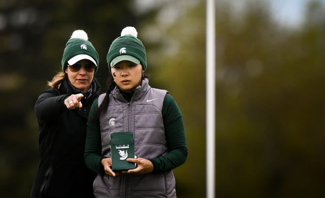 In this file photo, Michigan State University women's golf coach Stacy Slobodnik-Stoll (left) talks putting strategy with sophomore Yurika Tanida during an NCAA regional at Forest Akers West in East Lansing on May 8, 2019. The Spartans will play in their 22nd NCAA regional since 1999 after it earned an at-large bid to the Stillwater Regional on Wednesday.