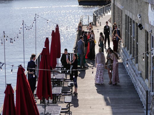 Prom goers gather outside the Waterfront Wine Bar for photo ops near the Manitowoc River Saturday, May 4, 2019, in Manitowoc, Wis. Joshua Clark/USA TODAY NETWORK-Wisconsin