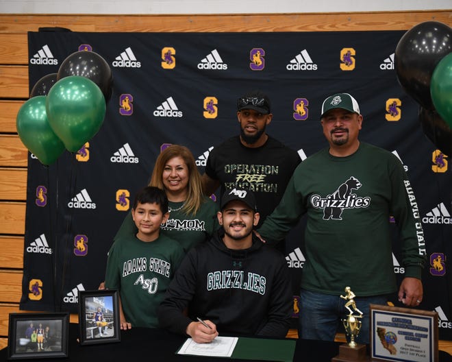 Ivan Curiel Jr. (front, center) signed his official letter of intent Wednesday to play football with the Adams State Grizzlies.