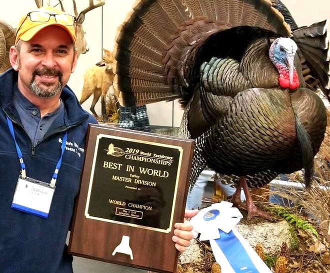 Harold McGuire displays his turkey mount and best-in-world award at the Taxidermy World Championships Friday, May 3, in Springfield, Missouri.