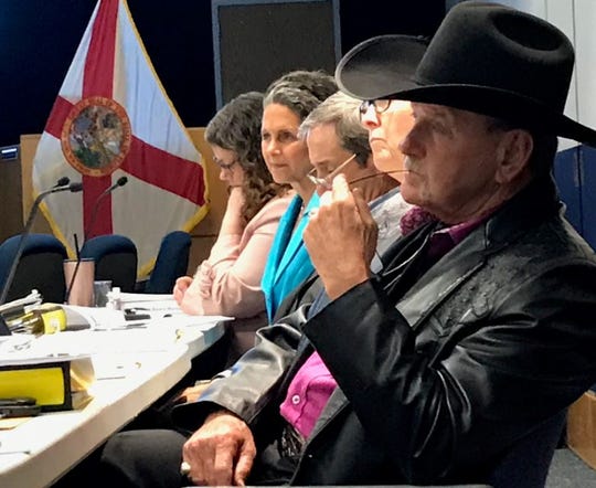 South Florida Water Management District board members including Jacqui Thurlow-Lippisch of Sewall's Point, second from left in blue, and Ron Bergeron of western Broward County, in cowboy hat, listen to a presentation Wednesday, May 8, 2019, during a board workshop on water quality.