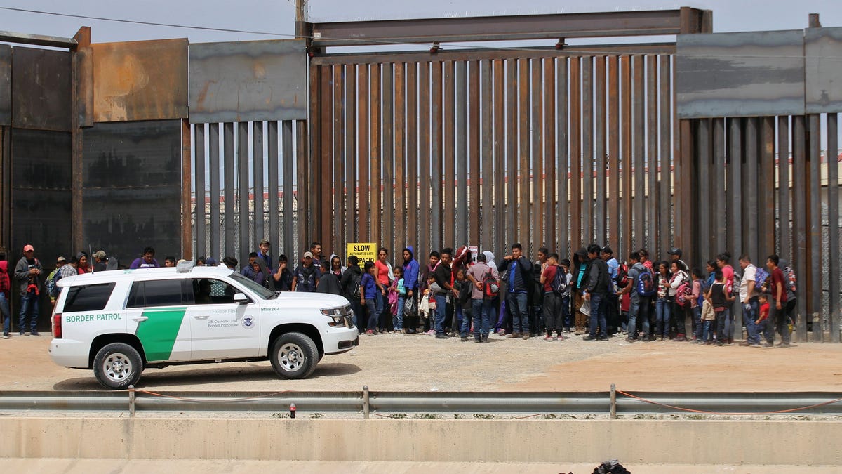 Central American migrants are detained by U.S. Border Patrol agents at the border wall near Ciudad Juarez, Mexico, on May 7, 2019.