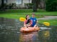 Siblings Katie and Lander Meinen survey their street by kayak with their dog, Bailey, in the Colony Bend neighborhood of Sugar Land. Residents have been surprised that the water has not receded more quickly as it has in the past when the rain has stopped.
