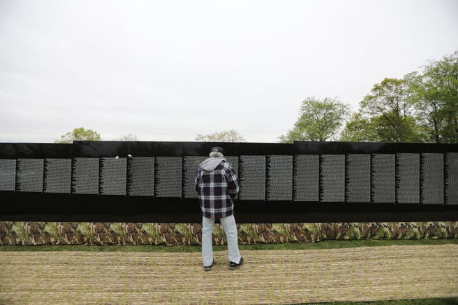 A man looks at the Moving Wall, a replica of the Vietnam Veterans Memorial, which is currently on display at Garret Mountain Reservation, in Paterson.  Thursday, May 9, 2019