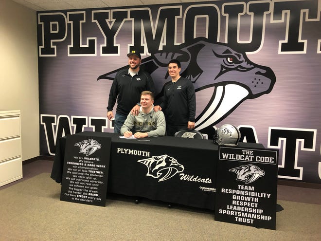 Plymouth's Luke Fisher will be a preferred walk-on at Michigan. He's pictured here with Plymouth head coach Brian Lewis (left) and offensive line coach Cory Zirbel (right).
