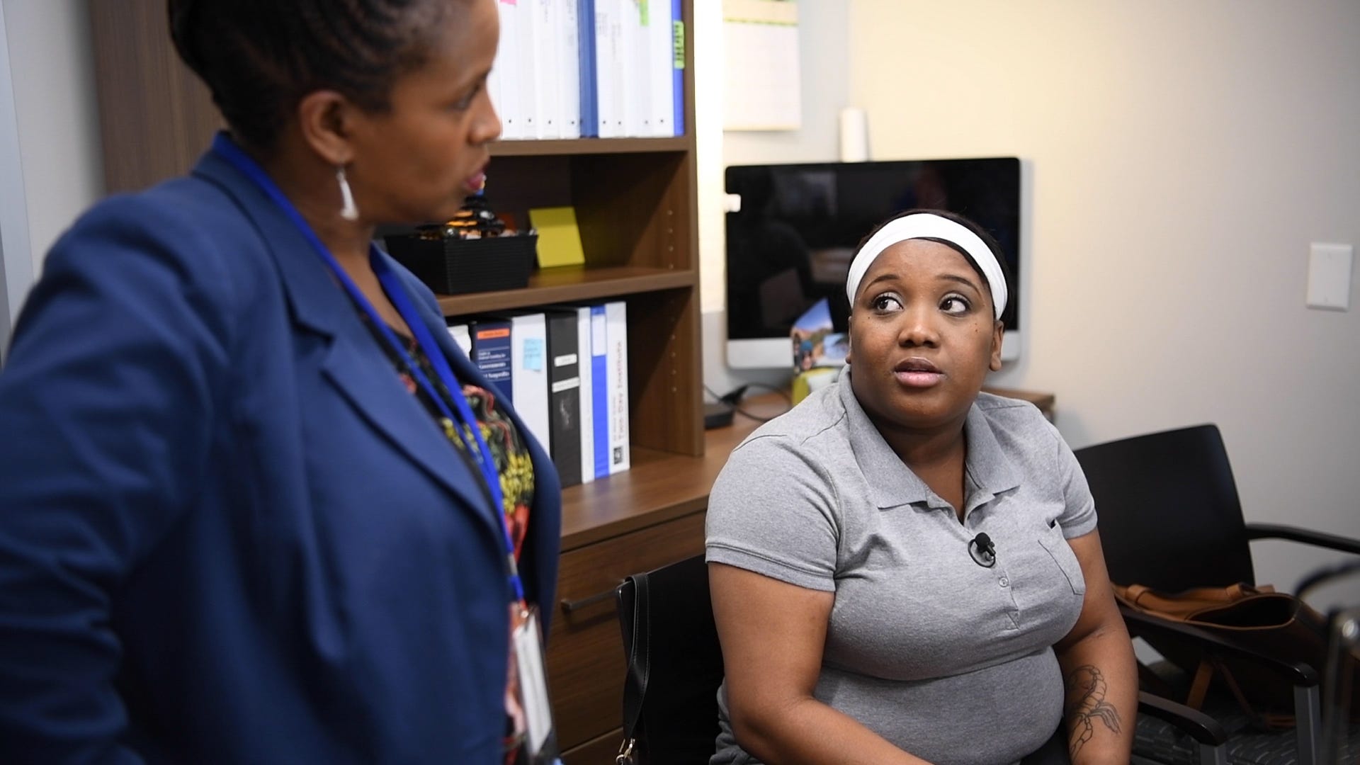 C'alra Bradley, right, speaks with Sivivian Merrick, her former caseworker, at the offices of SER Jobs Houston.