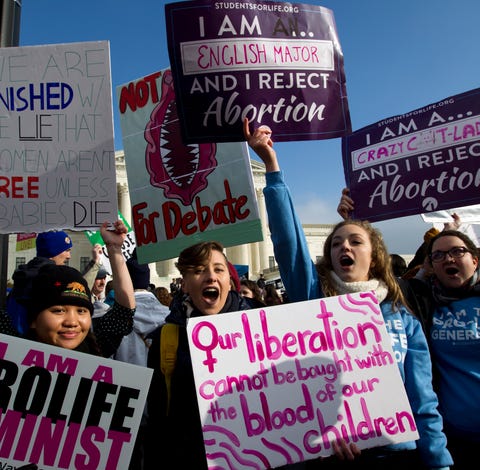 Anti-abortion activists protest outside of the...